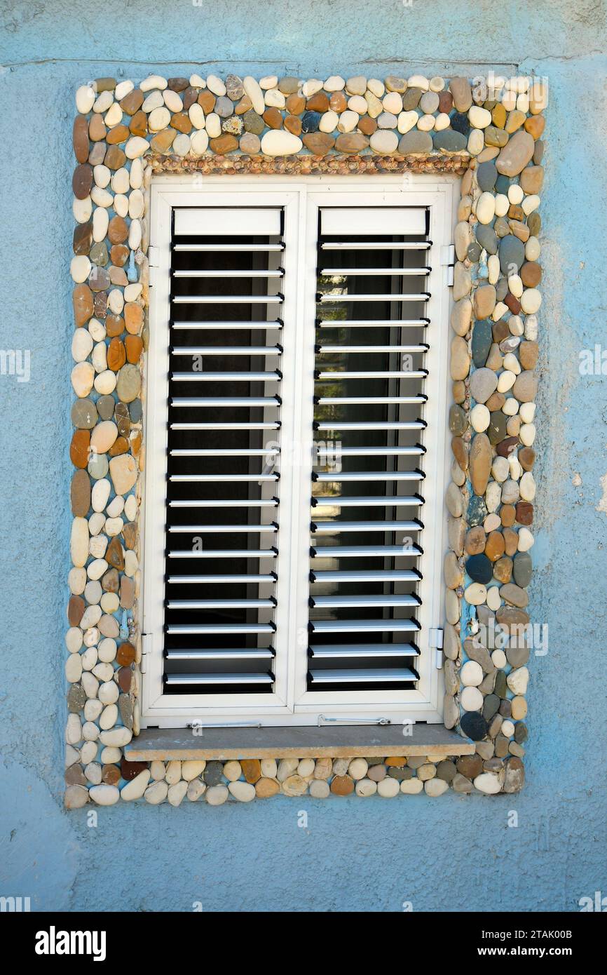 Cyprus, window with blinds framed with colorful stones  in old town of Paphos aka Pafos - city was European Capital of Culture in 2017 Stock Photo