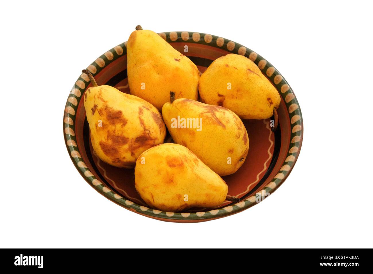 Pears in a clay beige plate. Farm pears in rustic bowl. Isolate on a white background. Harvest. Stock Photo