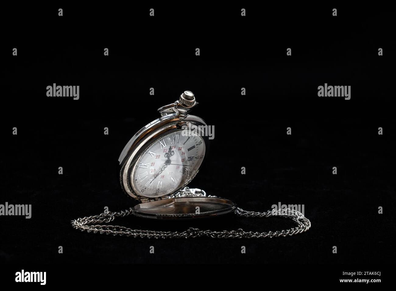 A silver pocket watch isolated on black background Stock Photo