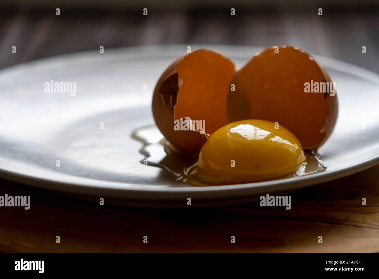 Fresh egg yolk on a plate Stock Photo