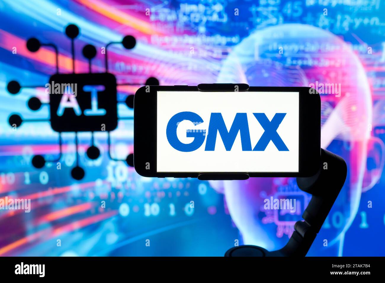 In this photo illustration, the logo of GMX is seen displayed on a mobile phone screen with AI (artificial intelligence) symbol in the background. Stock Photo