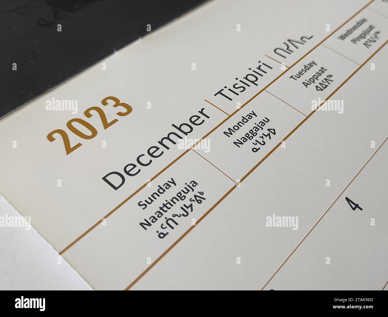 A calendar for December 2023 with English and Inuktitut languages Stock Photo