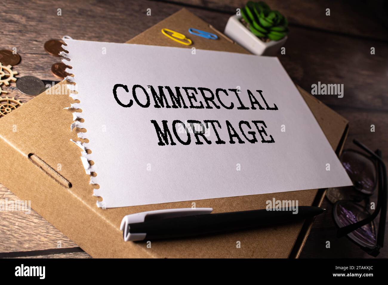 COMMERCIAL MORTGAGE, text on white notepad paper. on a white photo with torn paper. Stock Photo