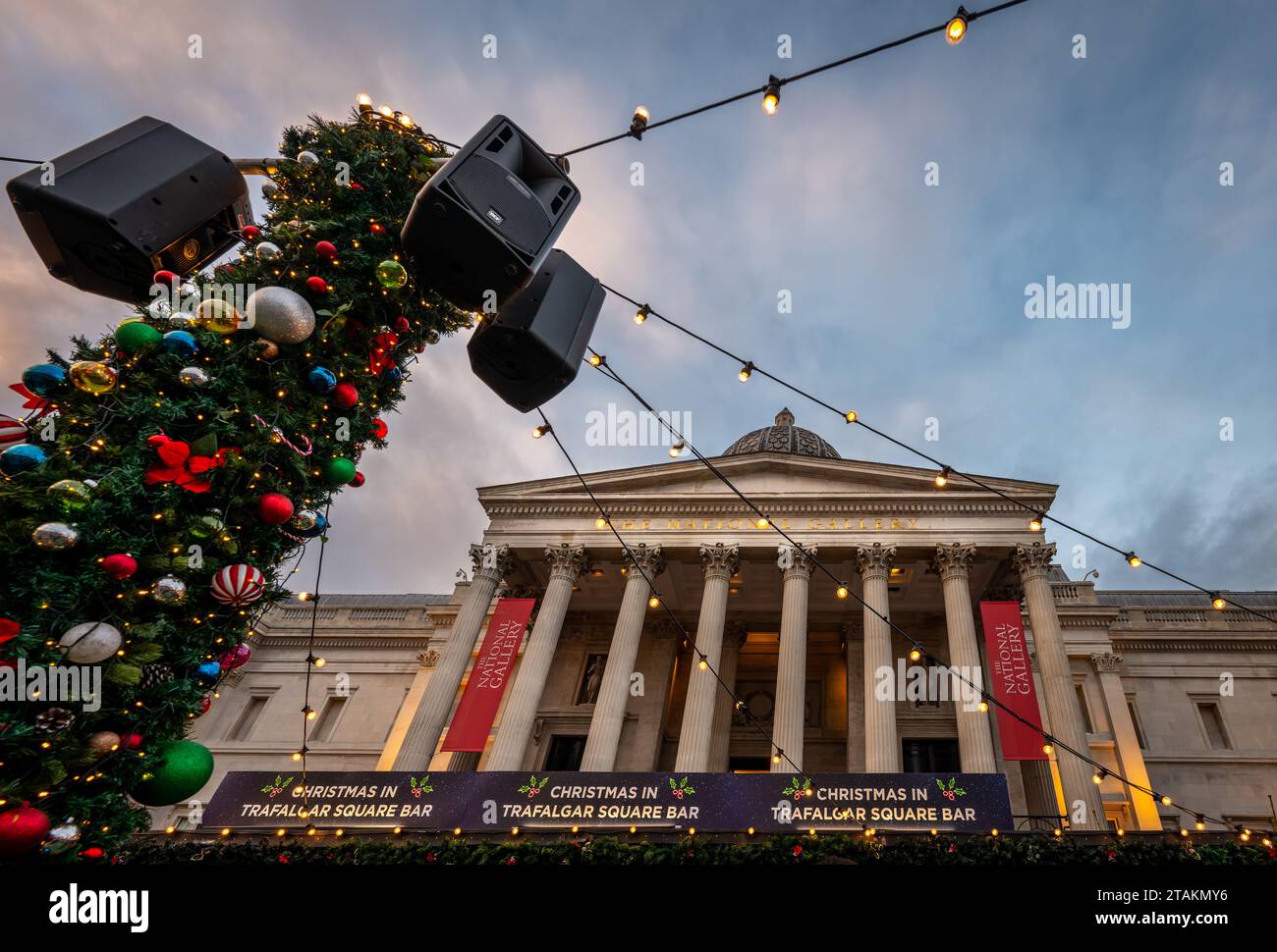 London, UK - Nov 20 2023: The National Gallery in Trafalgar Square, London. Decorations at the Trafalgar Square Christmas Market in the foreground. Stock Photo