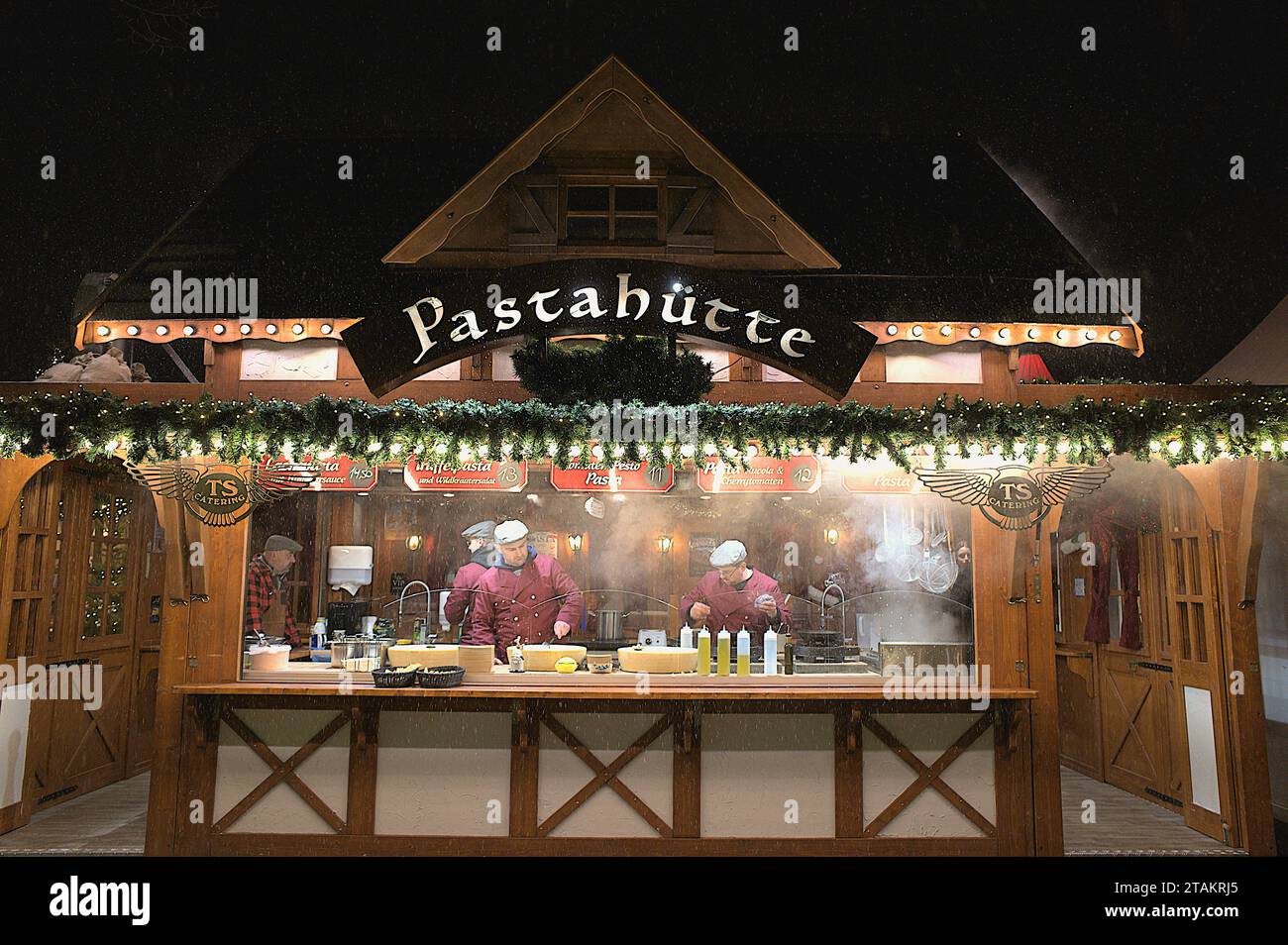 Pastahütte at a Christmas Market at Charlottenburg Palace, while it is snowing in Berlin, Germany Stock Photo