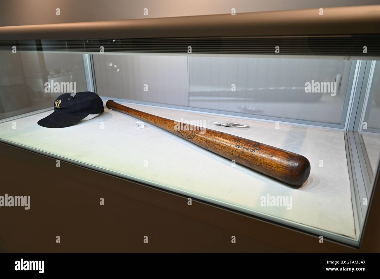 A Lou Gehrig Professional Model baseball Bat and hat on display "The