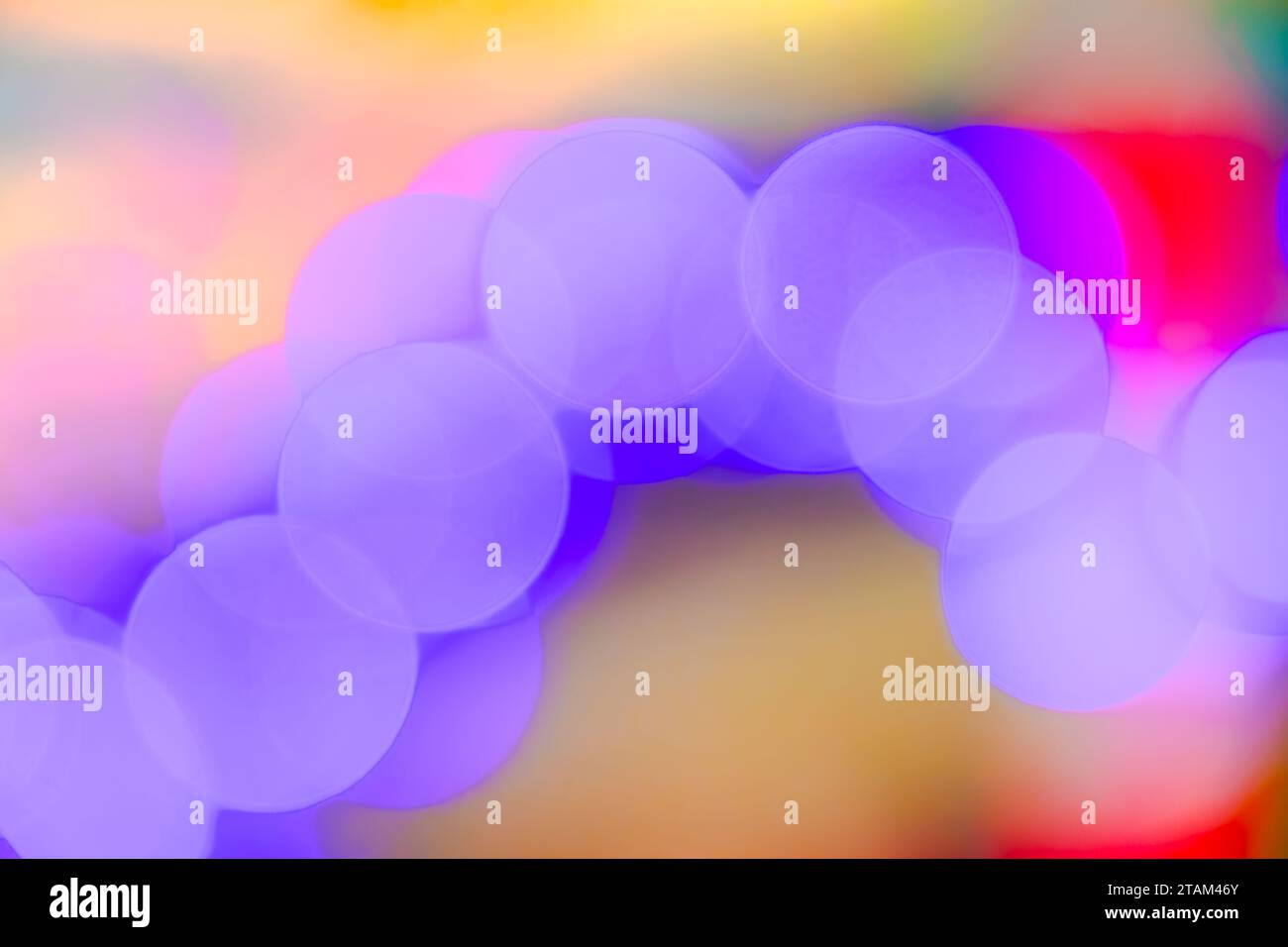 Abstract blurry purple soft bokeh light circles glowing on colorful background, close up Stock Photo