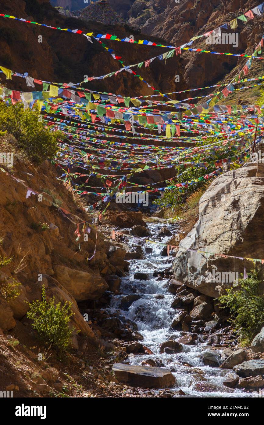 Prayer flags at Chungsi Cave  also known as  Rangchung Cave, a Buddhist pilgrimage place where Padmasambhava meditated in the 8th century - Mustang Di Stock Photo