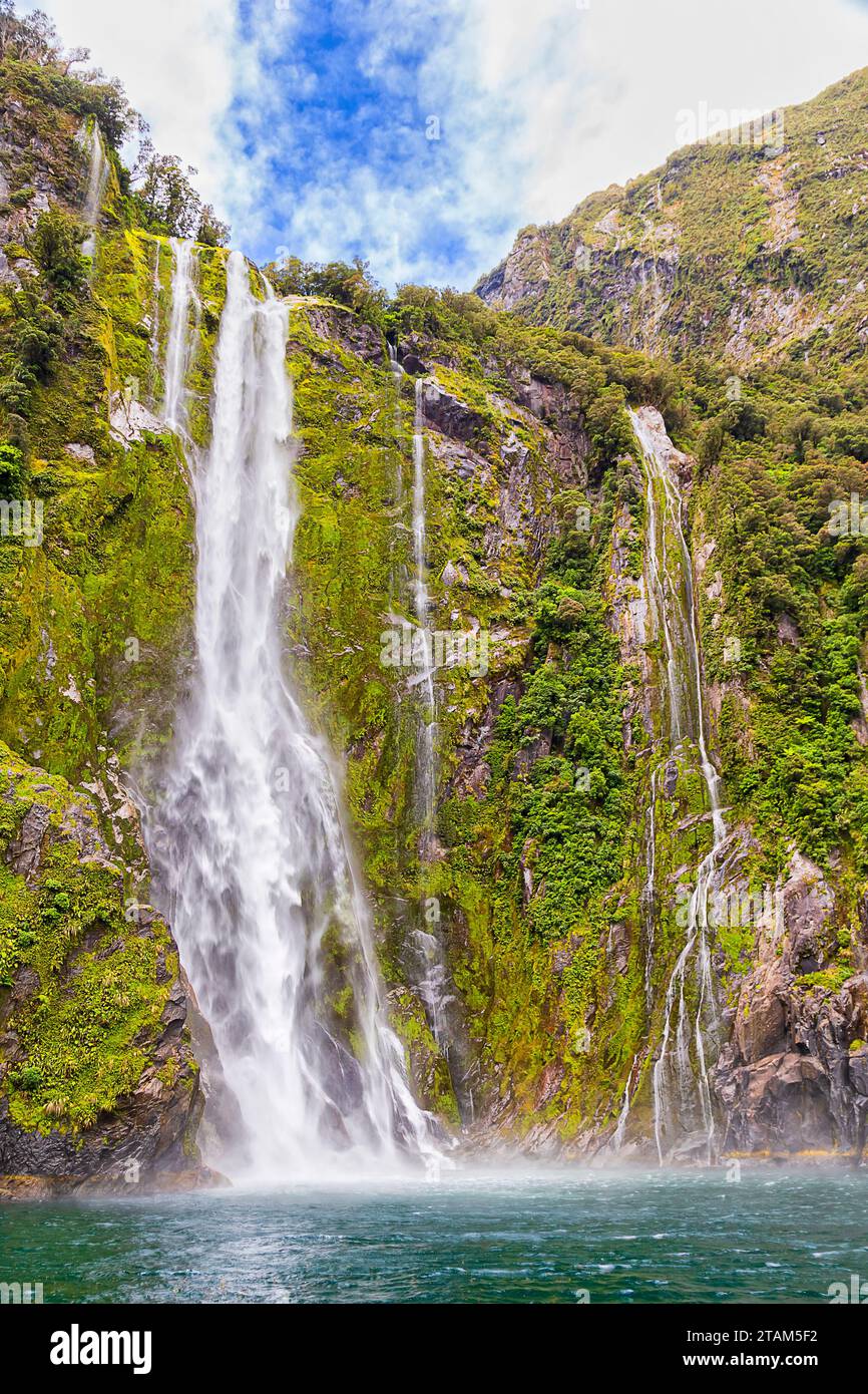 Mighty Stirling falls from melting glaciers in Milford Sound fiord of New Zealand. Stock Photo