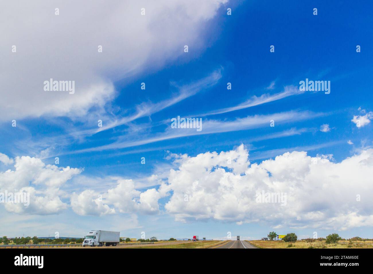 Patterns in cloud formations against a blue sky over Interstate 40 in New Mexico. Stock Photo