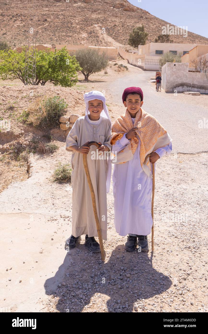 Tunisia. March 17, 2023. Boys in traditional dress in the Tunisian desert. Stock Photo