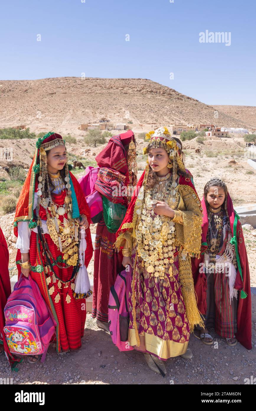 Tunisia. March 17, 2023. Girls in traditional dress in the Tunisian desert. Stock Photo