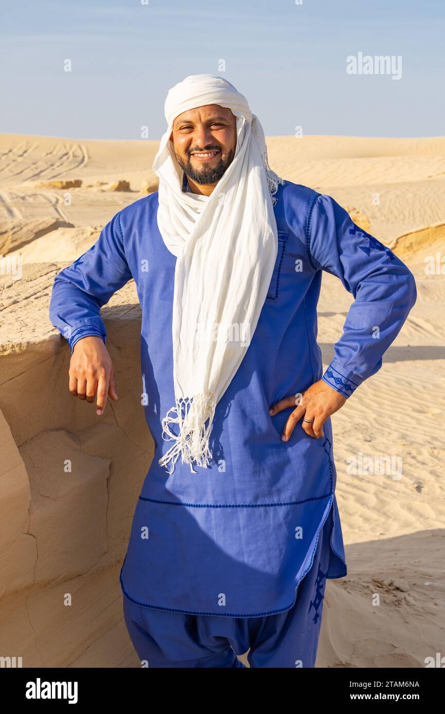 Nafta, Tozeur, Tunisia. March 18, 2023. Tunisian man wearing blue thaab in the desert. Stock Photo