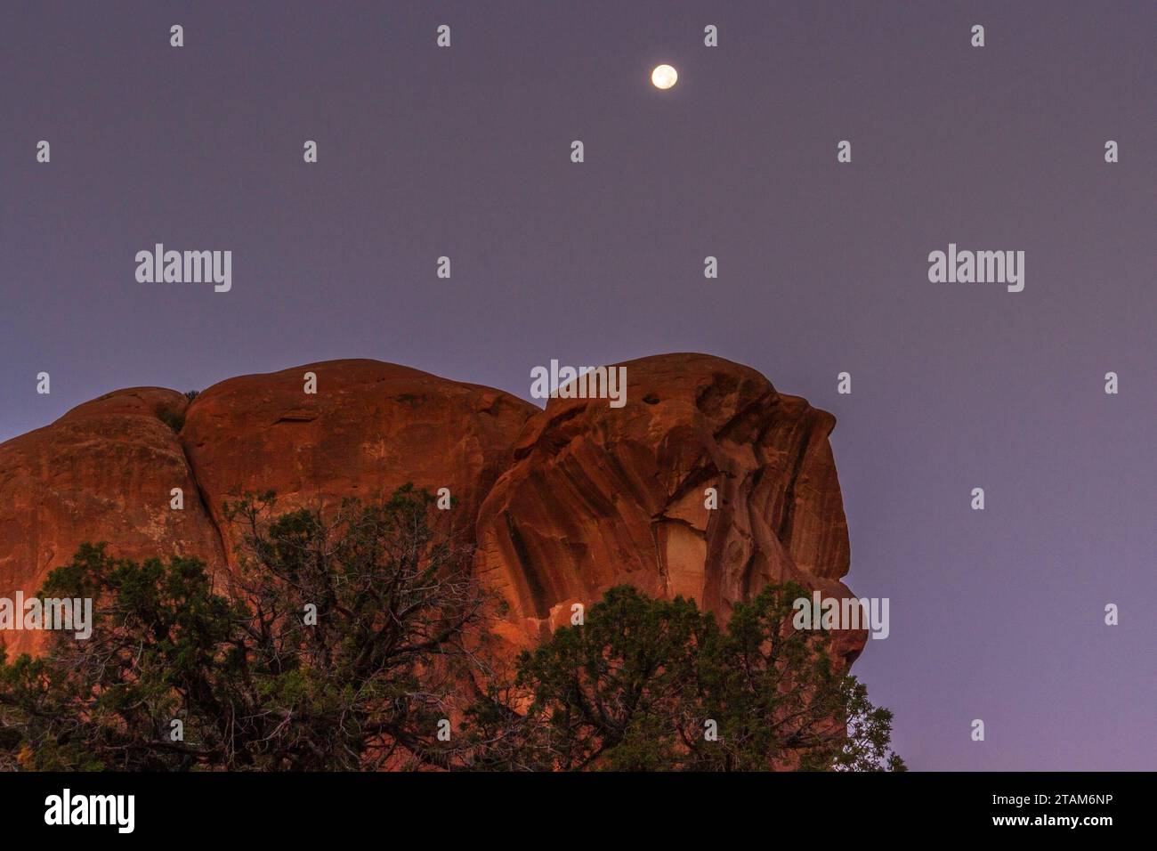 Moon setting in Arches National Park in Utah. Stock Photo