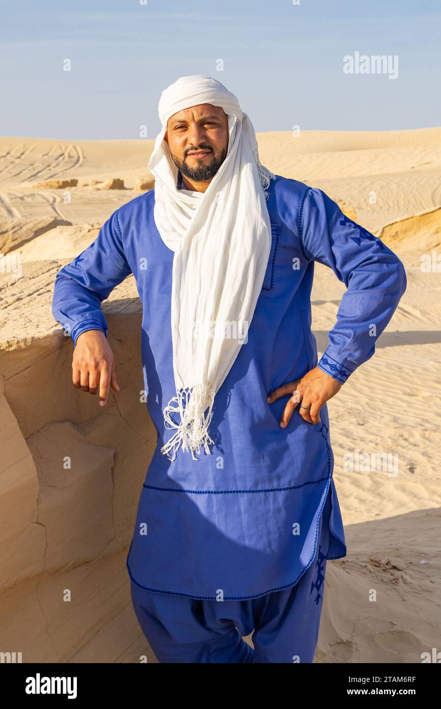 Nafta, Tozeur, Tunisia. March 18, 2023. Tunisian man wearing blue thaab in the desert. Stock Photo