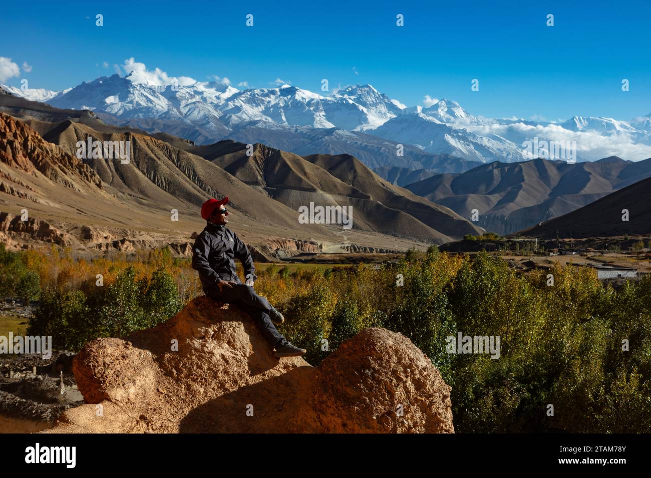 Bishnu enjoys the view in Dhakmar Village - Mustang District, Nepal Stock Photo