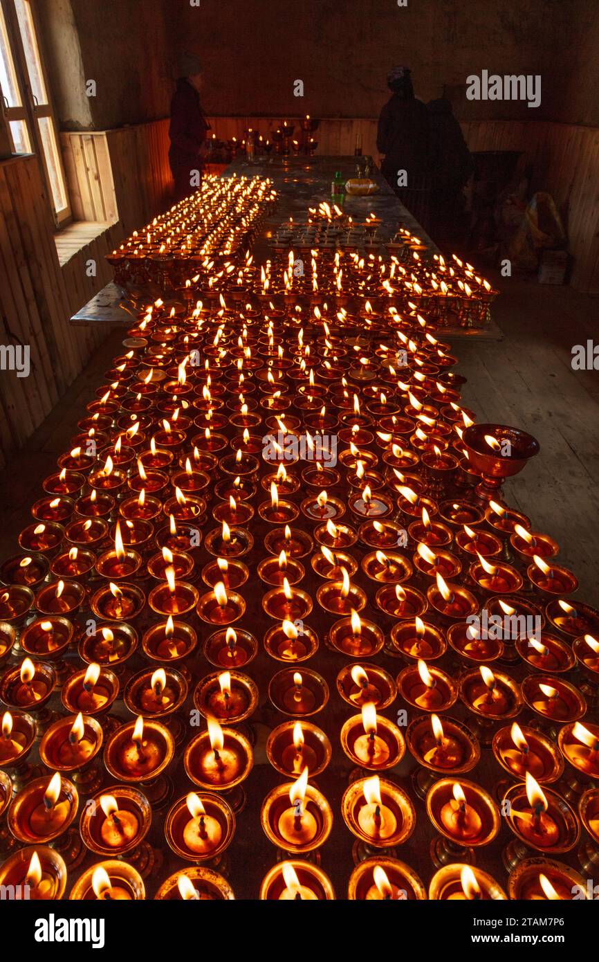 Puja candles are lit at Lo Gekar Monastery in Ghar village is the oldest Buddhist gompa in Nepal, built by Guru Rimpoche in the 8th century - Mustang Stock Photo