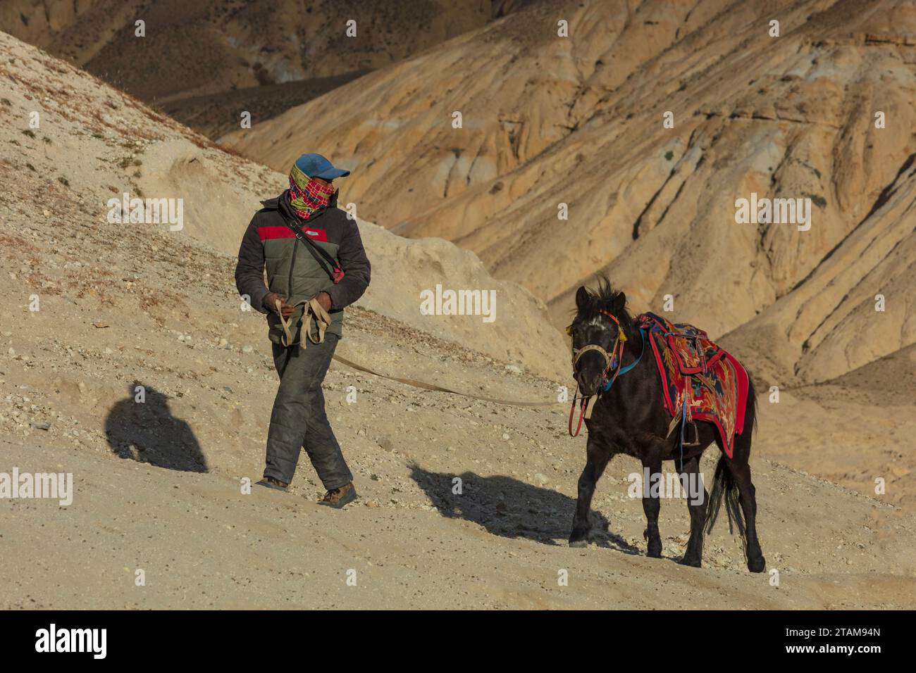 A man with his horse in the village of Garphu near Lo Manthang - Mustang District, Nepal Stock Photo