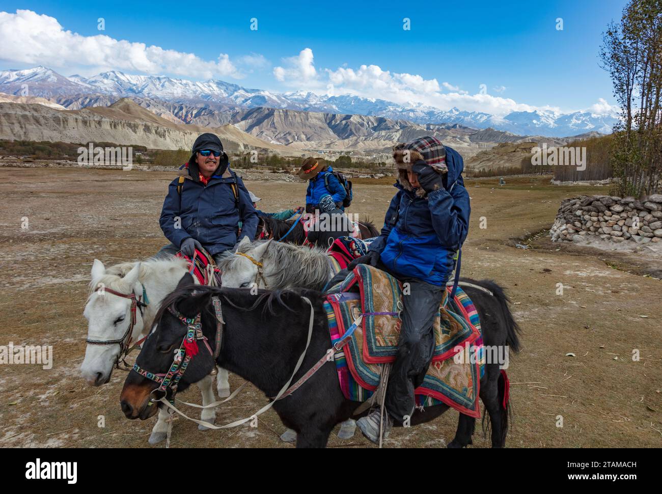 Craig Lovell, Christine Kolisch and Vajra Garrett on a horse ride from Thinggor village to Lo Manthang - Mustang District, Nepal Stock Photo
