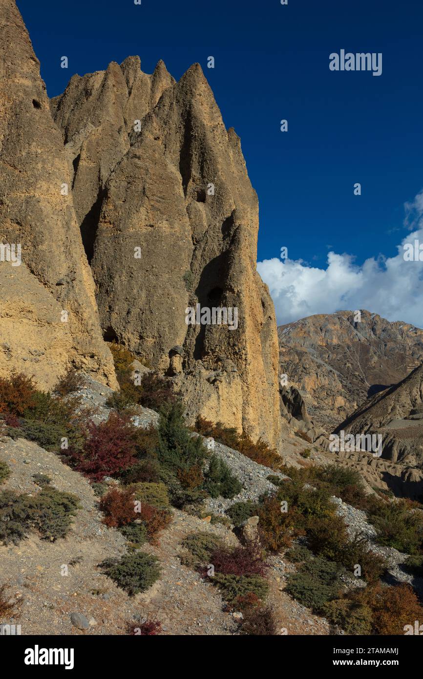 Hoodoo formations contain caves carved by humans 3000 years ago near Yara village - upper Mustang District, Nepal Stock Photo