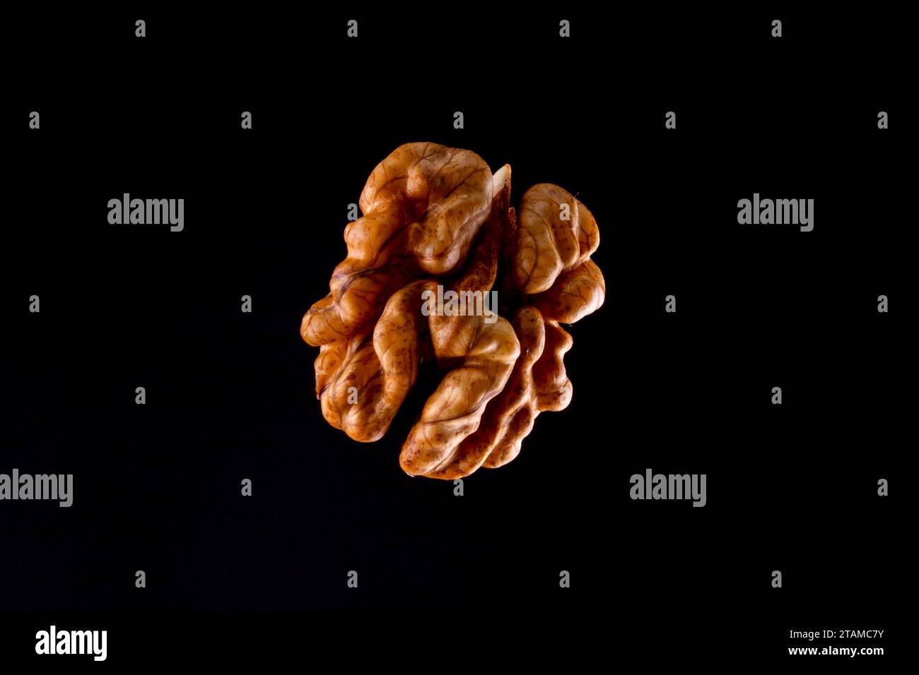 Walnuts on a black brown background. Stock Photo