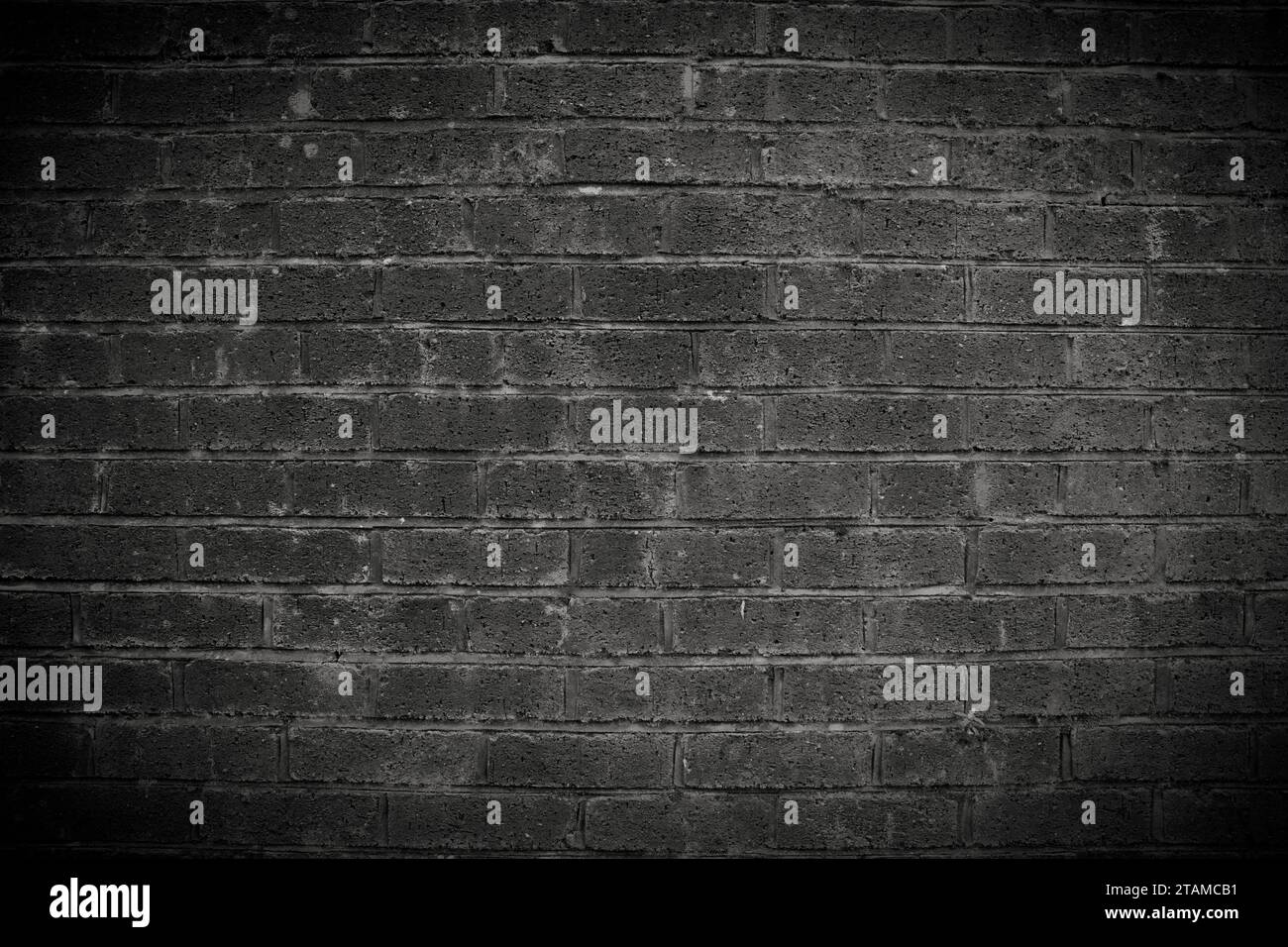 An old wall made of bricks dramatic dark background Stock Photo - Alamy