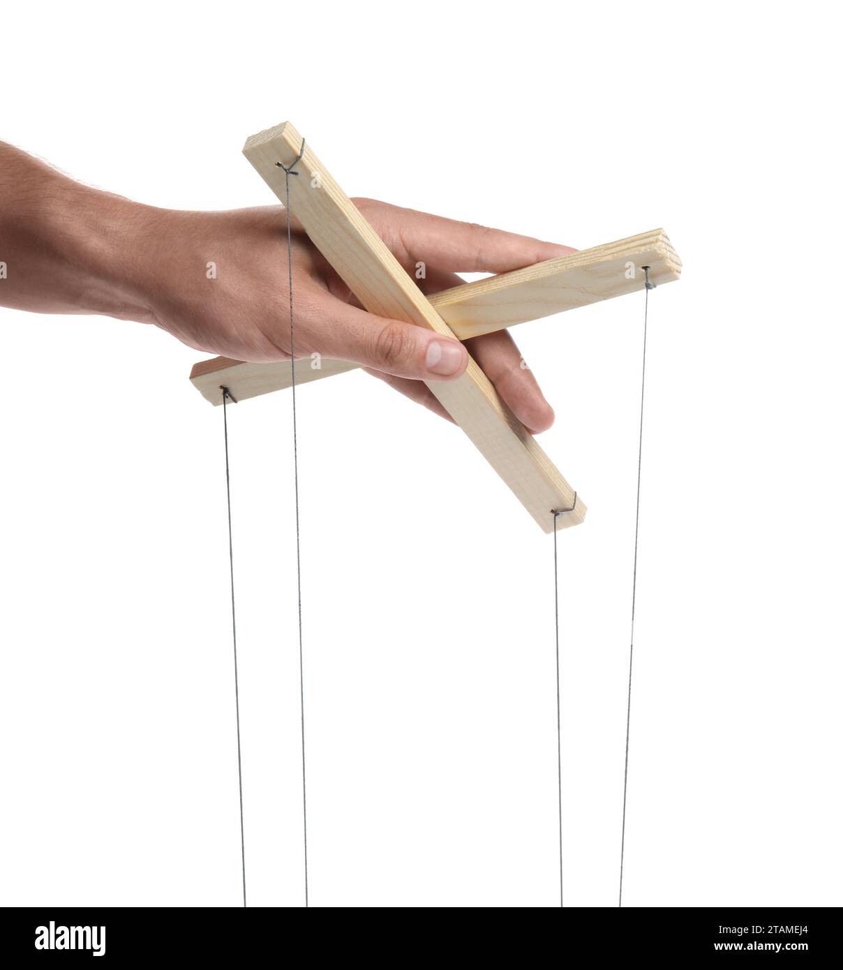 Man holding puppet control bar with strings on white background, closeup Stock Photo