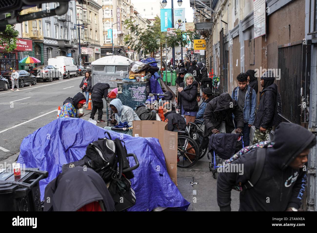 San Francisco, United States. 01st Dec, 2023. Homeless people gather next to their tents on the street. The issue of homelessness remains a significant concern in San Francisco, California, with thousands of individuals living on the streets. Many of the homeless population are linked to various crimes, including drug-related activities and instances of theft. A policy has been implemented that providing homeless individuals with a minimum of 15 minutes to decide whether they wish to accept the city's offer of shelter. Credit: SOPA Images Limited/Alamy Live News Stock Photo