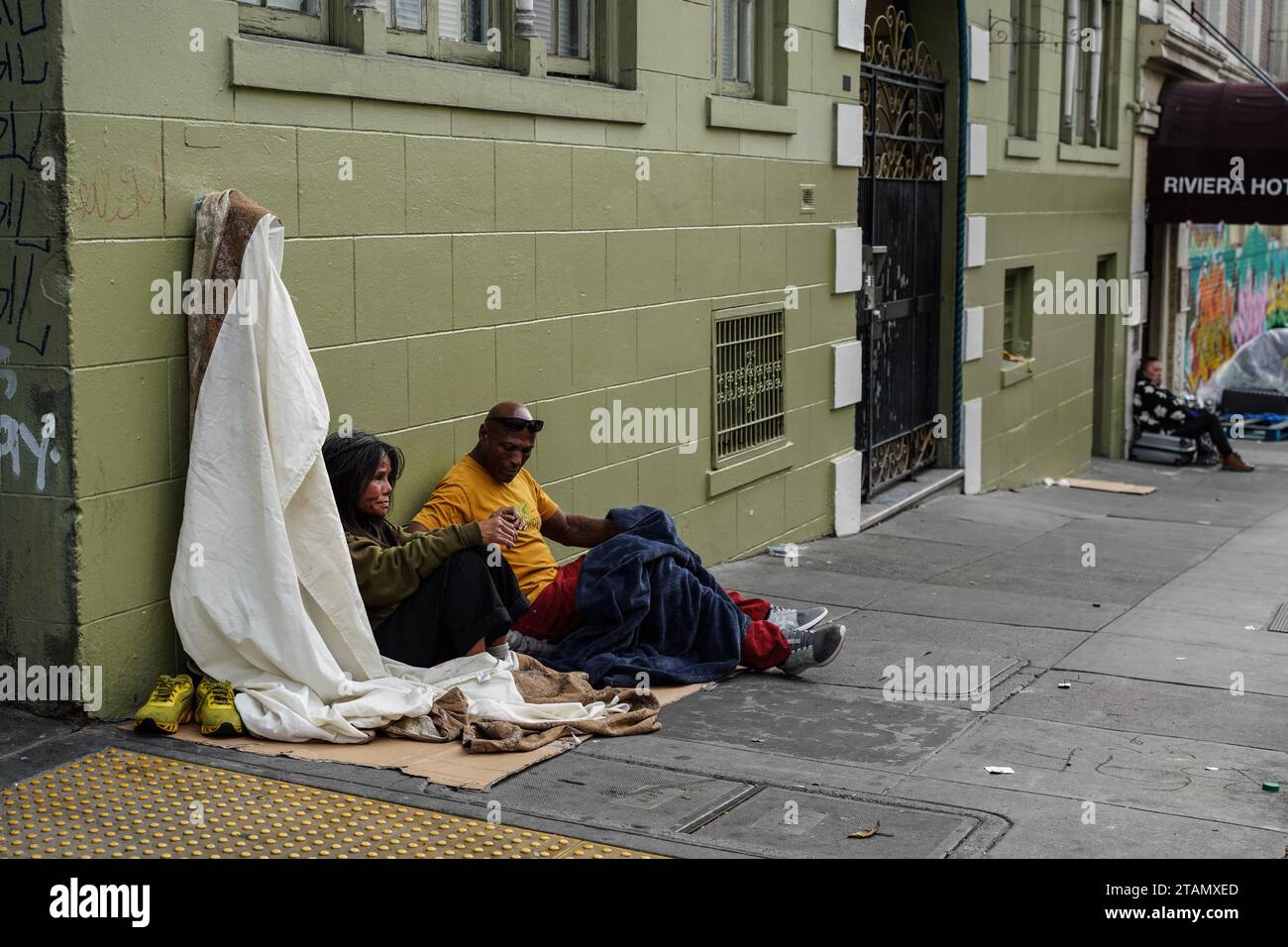 San Francisco, United States. 01st Dec, 2023. Two homeless people sit on the street. The issue of homelessness remains a significant concern in San Francisco, California, with thousands of individuals living on the streets. Many of the homeless population are linked to various crimes, including drug-related activities and instances of theft. A policy has been implemented that providing homeless individuals with a minimum of 15 minutes to decide whether they wish to accept the city's offer of shelter. Credit: SOPA Images Limited/Alamy Live News Stock Photo