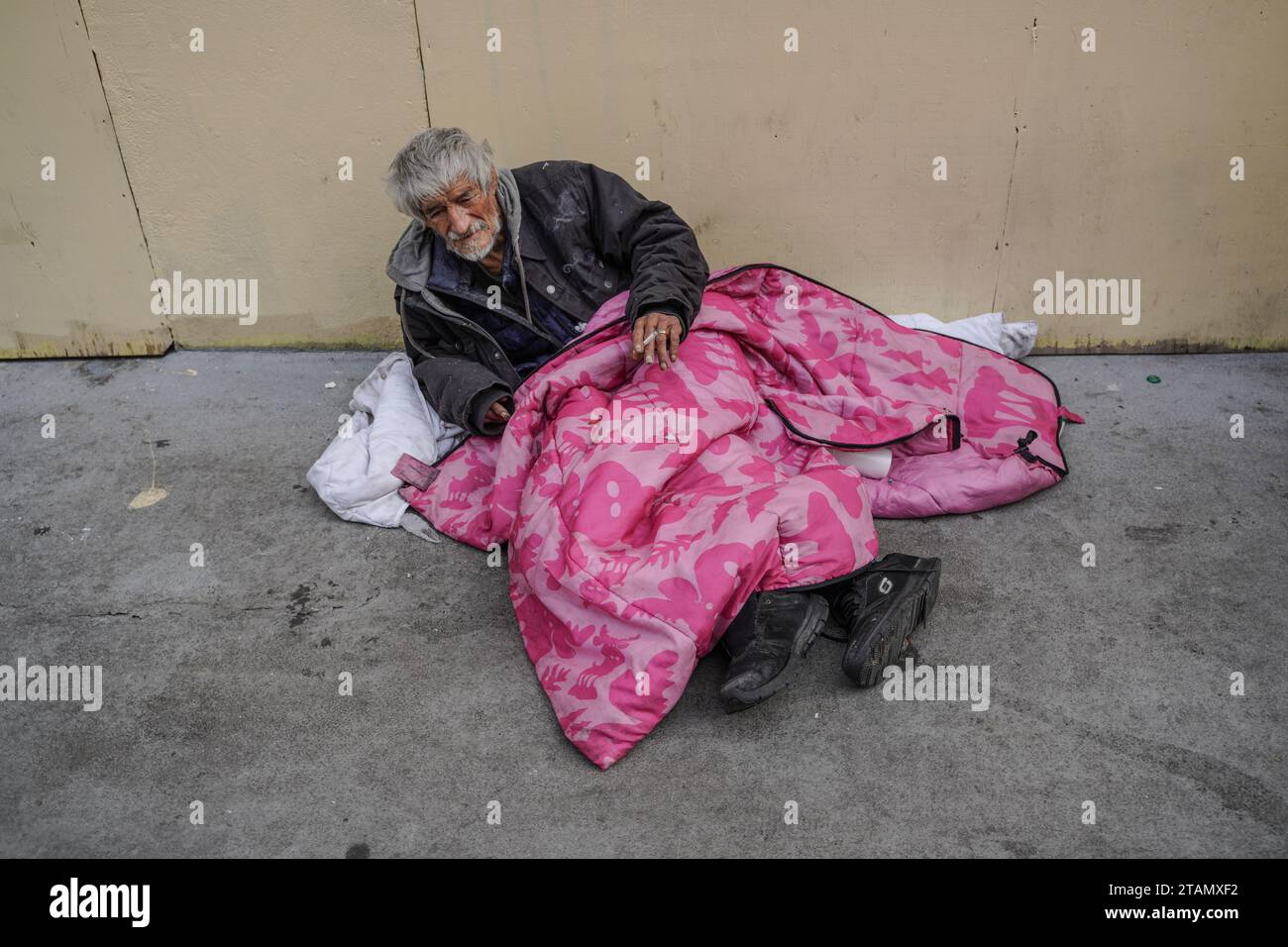 San Francisco, United States. 01st Dec, 2023. A homeless man sleeps on the street. The issue of homelessness remains a significant concern in San Francisco, California, with thousands of individuals living on the streets. Many of the homeless population are linked to various crimes, including drug-related activities and instances of theft. A policy has been implemented that providing homeless individuals with a minimum of 15 minutes to decide whether they wish to accept the city's offer of shelter. Credit: SOPA Images Limited/Alamy Live News Stock Photo