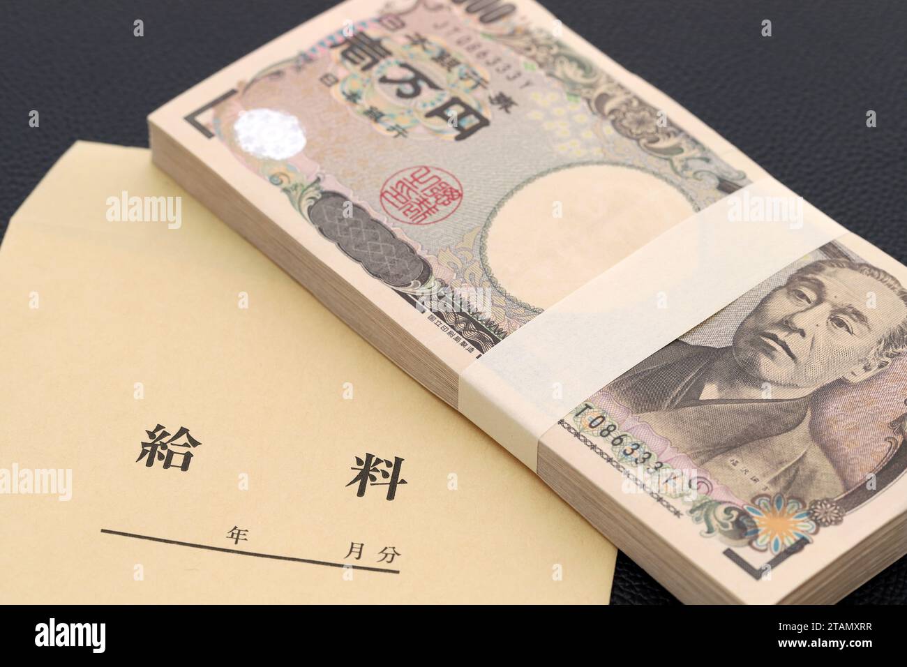 Japanese ten thousand yen on a salary bag on black background