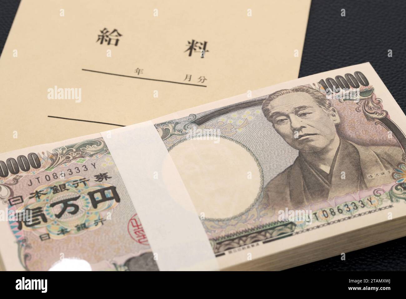 Japanese ten thousand yen on a salary bag on black background