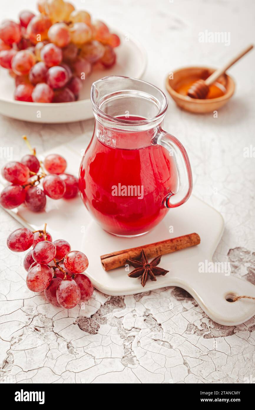 Homemade organic red vinegar with cinnamon and anise. Red grape balsamic vinegar made from fermented fresh grapes. Stock Photo