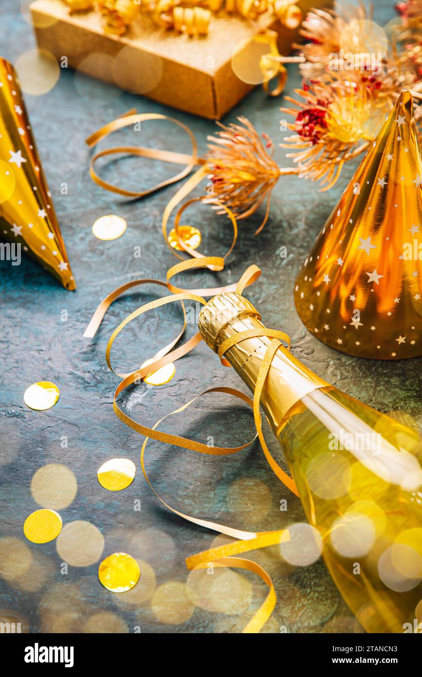 Happy New Year celebration,  bottle of champagne, bright lights and gifts Stock Photo