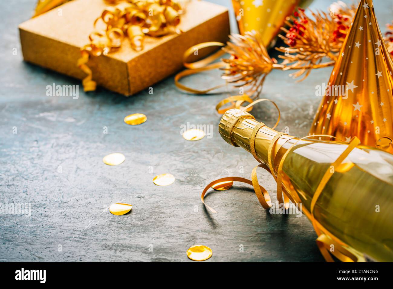 Happy New Year celebration,  bottle of champagne, bright lights and gifts Stock Photo
