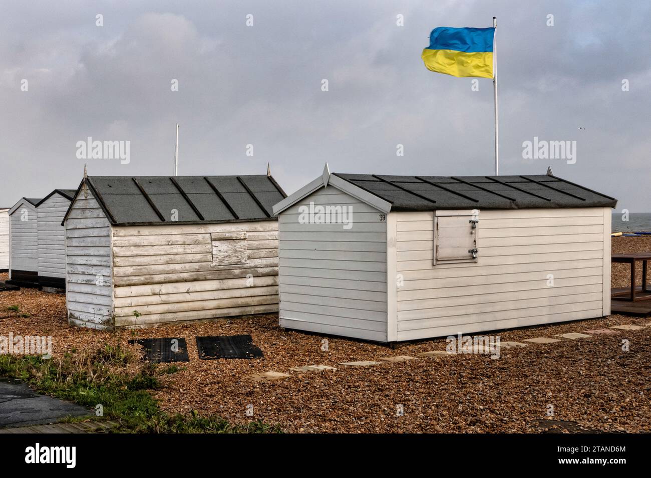 Beach huts with Ukrainian flag  at Deal Kent UK Stock Photo