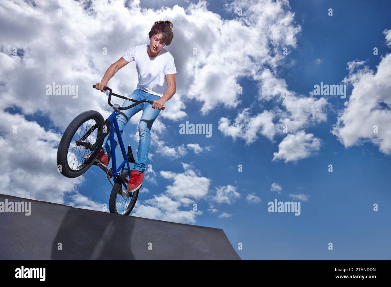 Riding, bike and teen on ramp for sport performance, jump or training ...