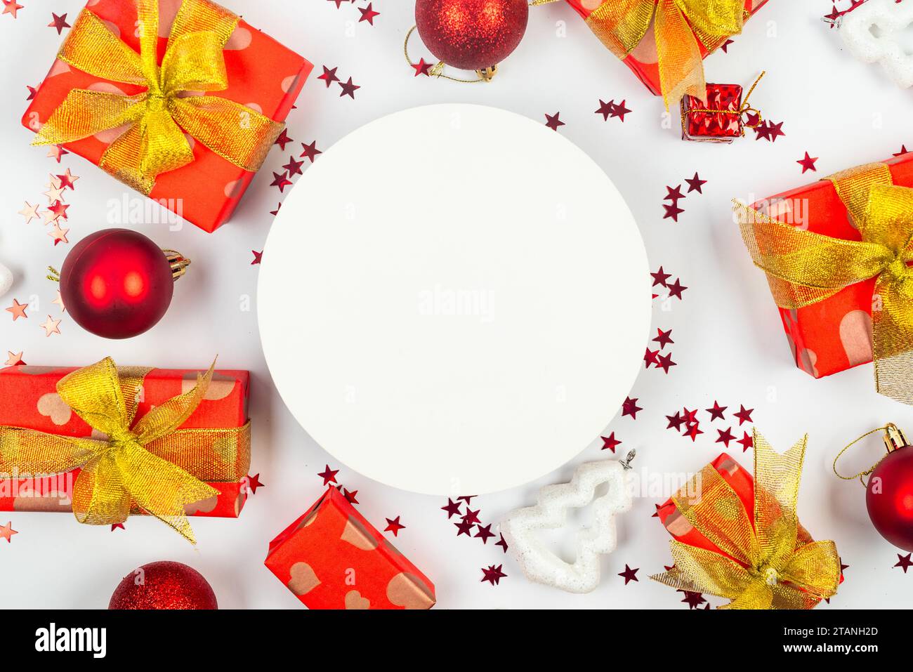 Red and gold christmas baubles, red gift boxes at white background ...
