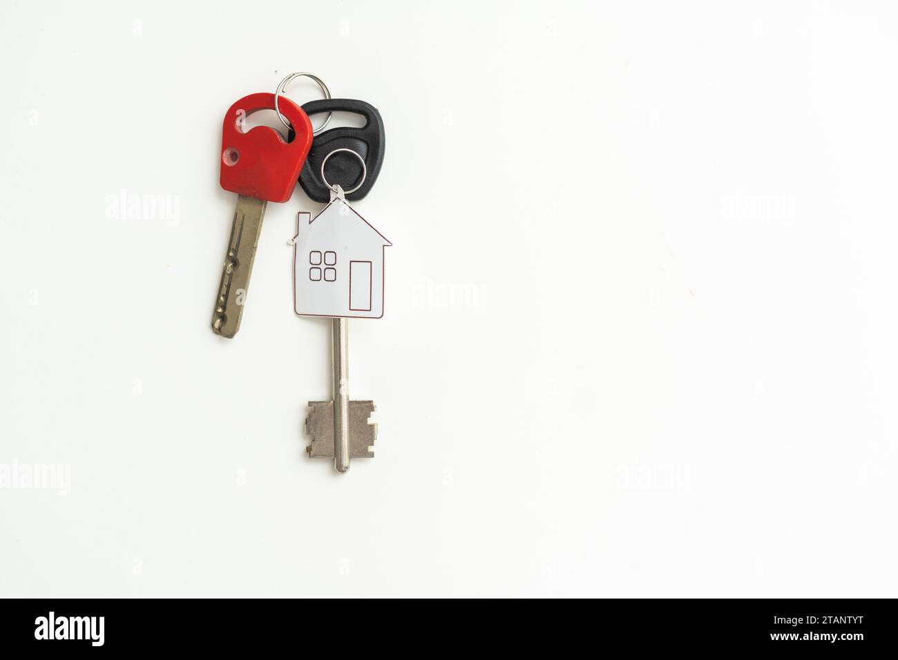 key chain with house symbol and keys on white background, Real estate ...
