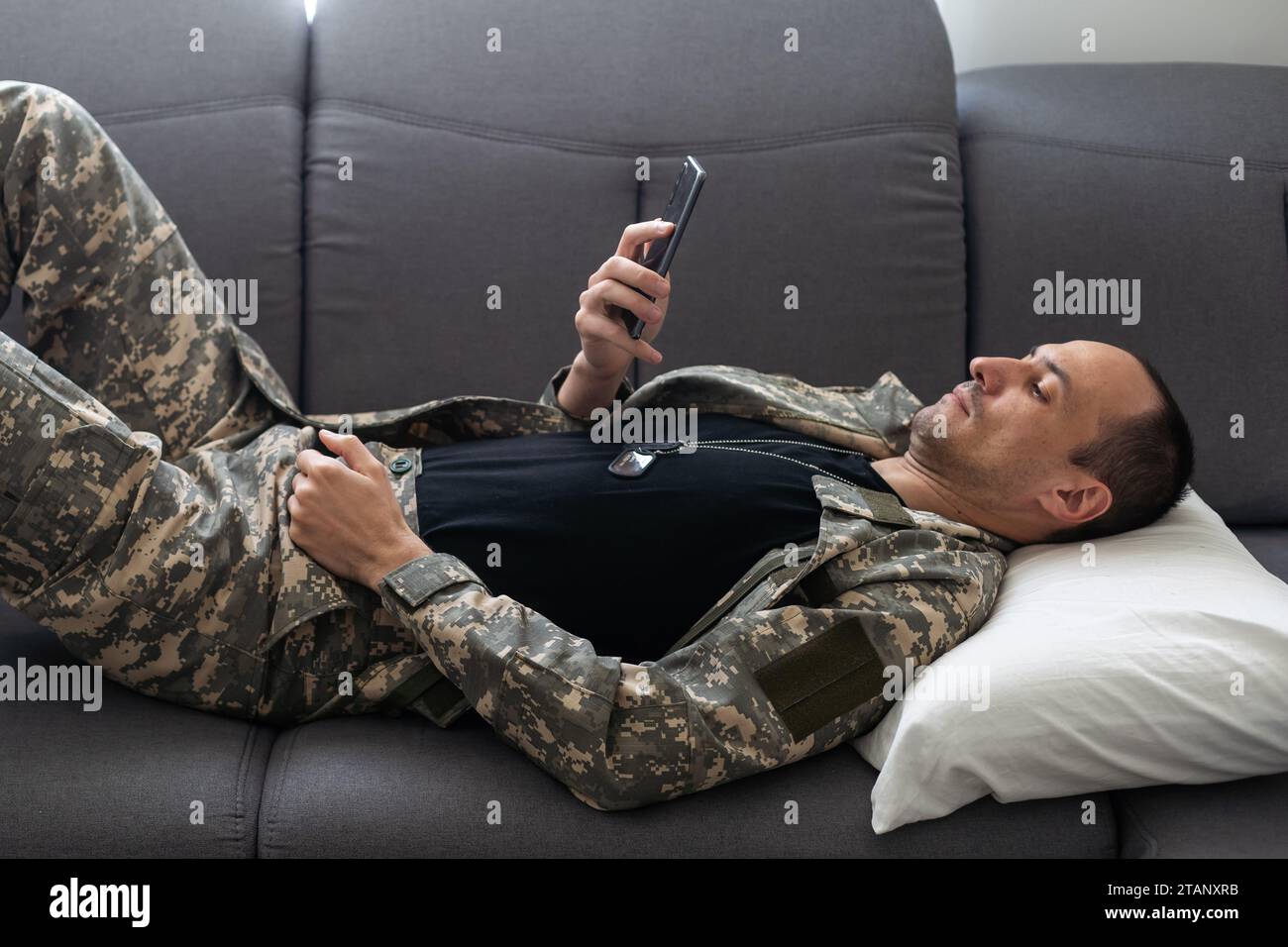tired african american soldier in military uniform sleeping in sofa at