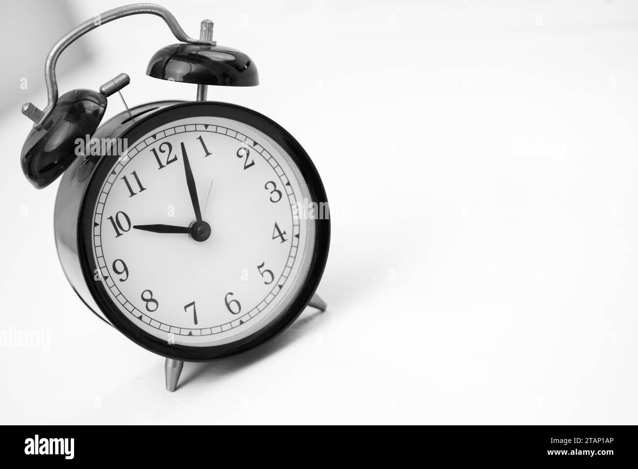 Black retro alarm clock on white background. Copy space Stock Photo
