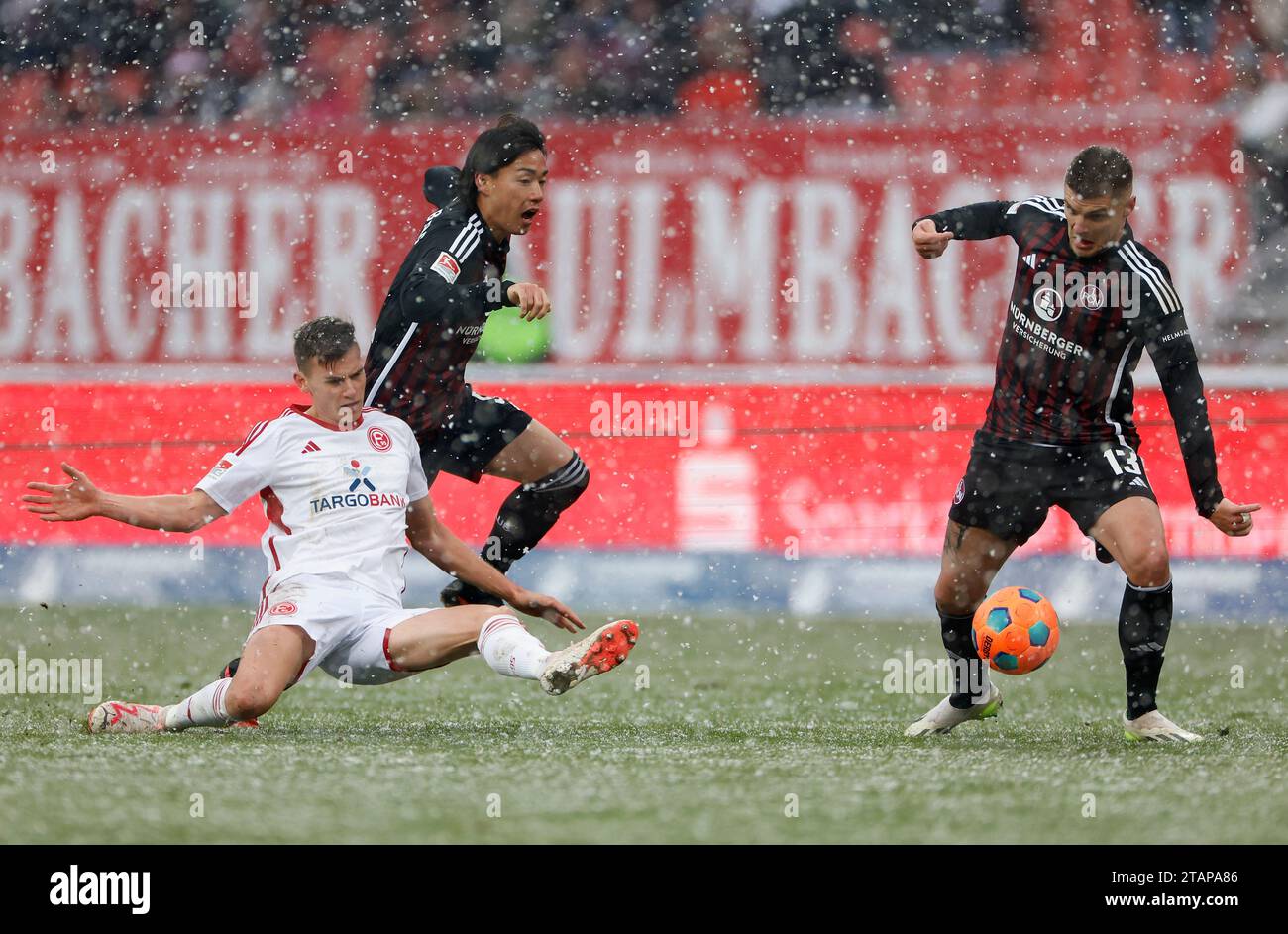 Nuremberg, Germany. 02nd Dec, 2023. Soccer: Bundesliga 2, 1. FC Nürnberg - Fortuna Düsseldorf, Matchday 15, Max-Morlock-Stadion. from left: Yannik Engelhardt (Fortuna Duesseldorf, 6), Daichi Hayashi (1.FC Nuernberg, 9) and Erik Wekesser (1.FC Nuernberg, 13). Credit: Heiko Becker/dpa - IMPORTANT NOTE: In accordance with the regulations of the DFL German Football League and the DFB German Football Association, it is prohibited to utilize or have utilized photographs taken in the stadium and/or of the match in the form of sequential images and/or video-like photo series./dpa/Alamy Live News Stock Photo