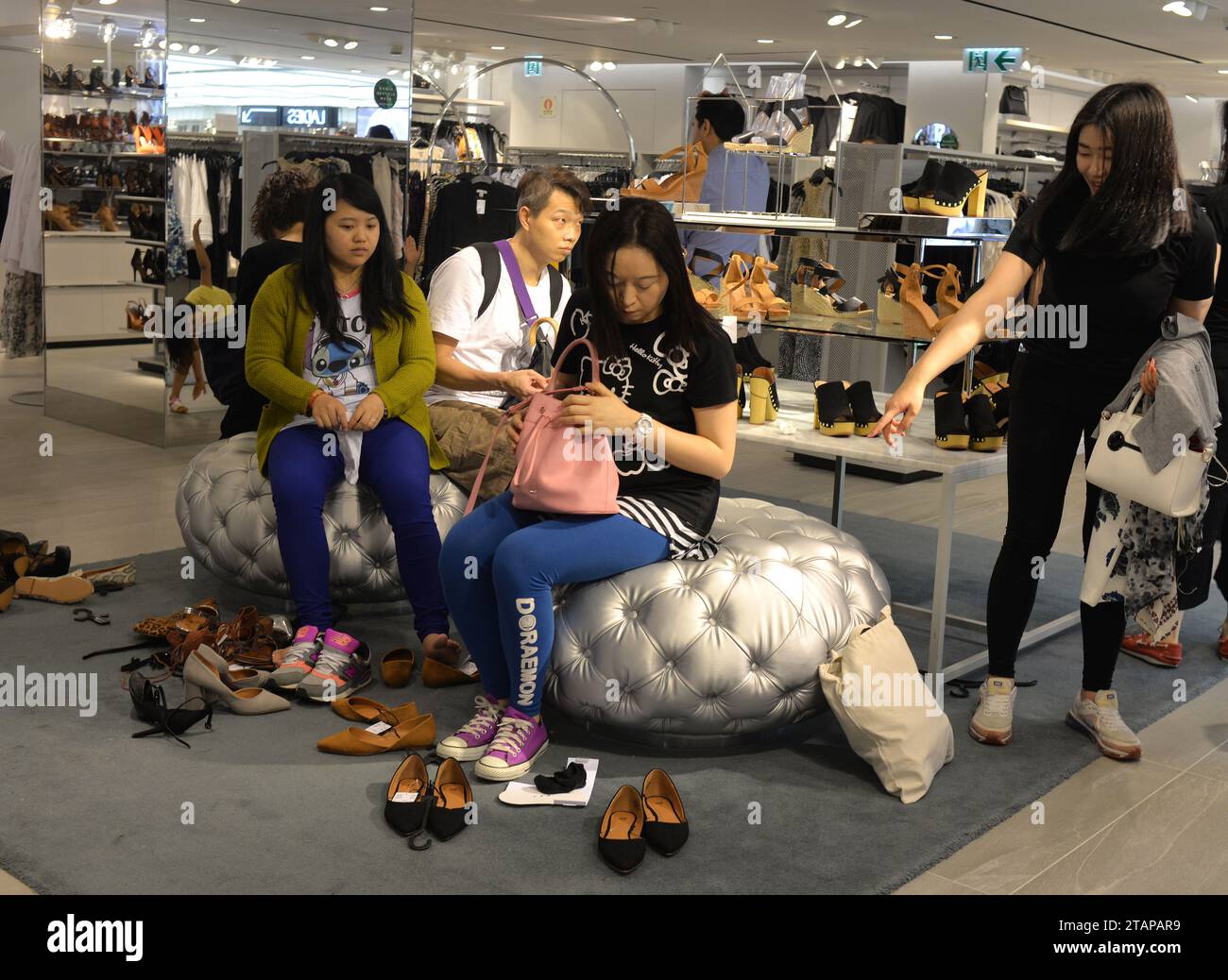 HONG KONG - APR 23, 2016: People in shoe store in Hong Kong. Footwear shop in Hong Kong. Stock Photo