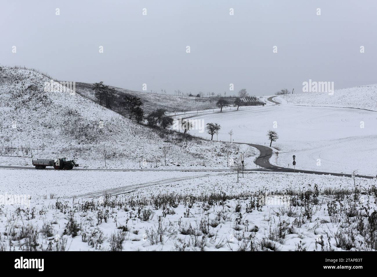 Coburg, Germany. 2 December 2023. Cold weather in northern Bavaria after heavy snowfalls as a tractor drives slowly down a country road. Credit: Clearpiximages/Alamy Live News Stock Photo