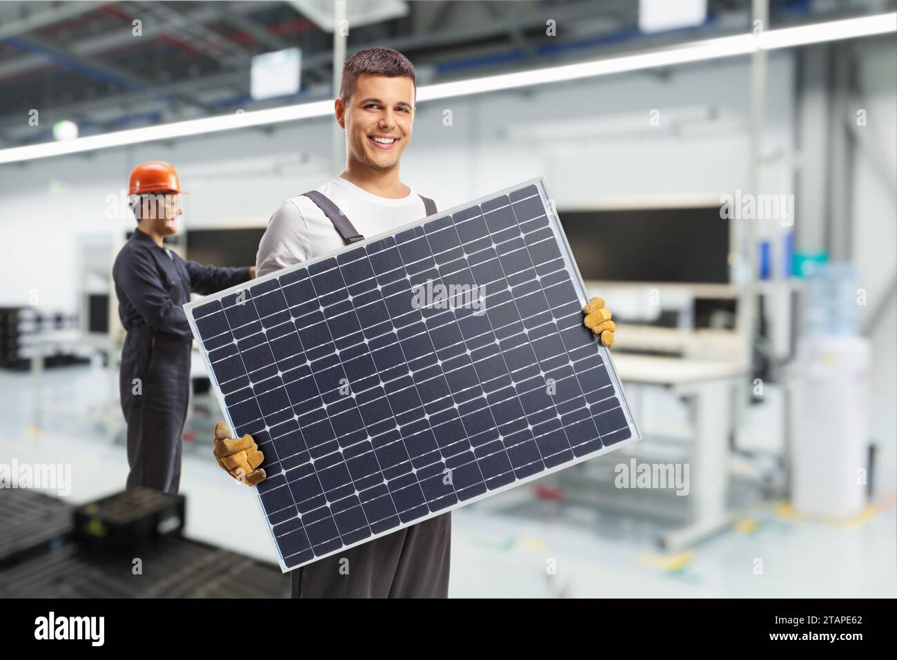 Solar panel manufacturing technology, workers at production line Stock