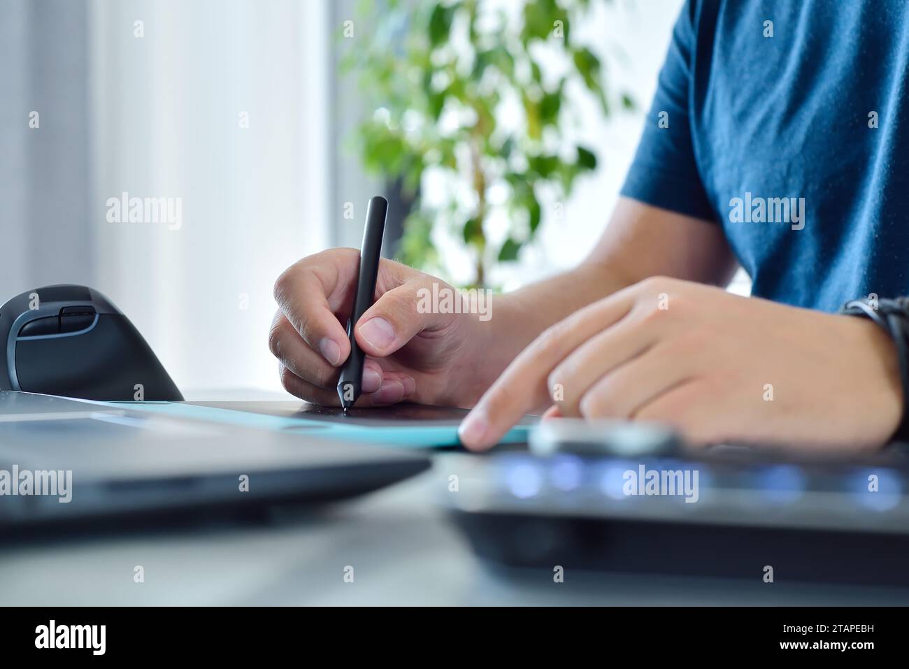 Graphic designer using digital control wheel keyboard and graphic ...