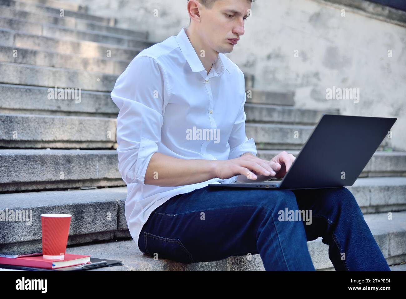 Businessman working outdoor on laptop computer. Business and education concept. Close up Stock Photo