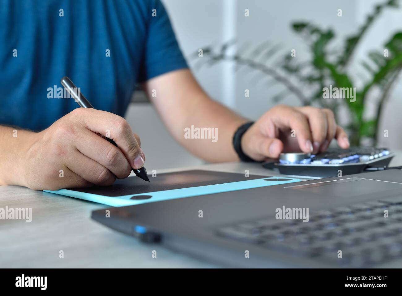 Graphic designer using digital control wheel keyboard and graphic ...