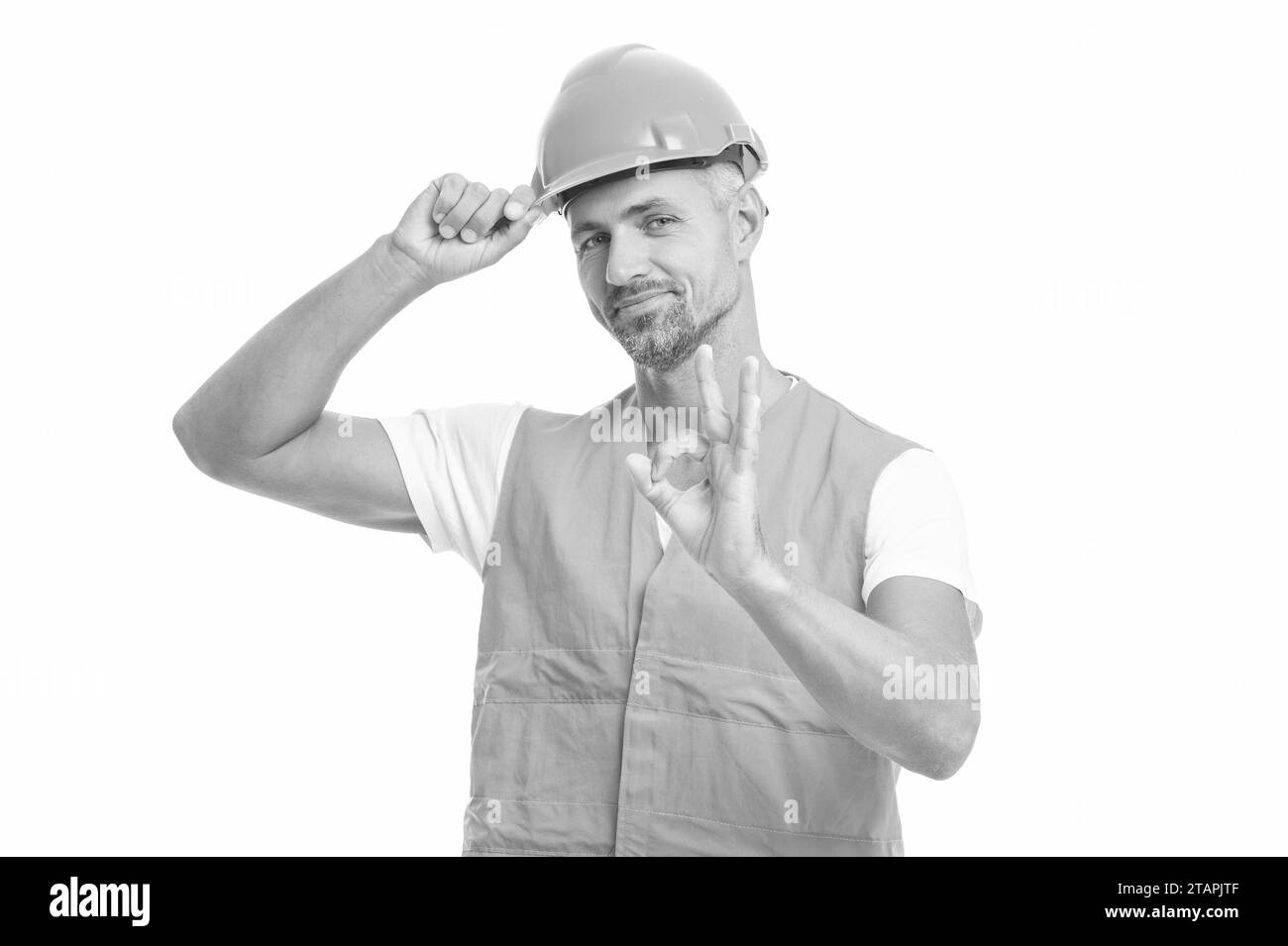 photo of man laborer wearing reflective vest, ok. man laborer isolated on white. man laborer in white studio. man laborer on background. Stock Photo