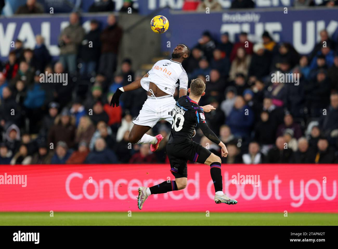 Swansea, UK. 02nd Dec, 2023. Yannick Bolasie of Swansea city controls the ball ahead of Ben Jackson of Huddersfield Town. EFL Skybet championship match, Swansea city v Huddersfield Town at the Swansea.com Stadium in Swansea, Wales on Saturday 2nd December 2023. this image may only be used for Editorial purposes. Editorial use only, pic by Andrew Orchard/Andrew Orchard sports photography/Alamy Live news Credit: Andrew Orchard sports photography/Alamy Live News Stock Photo